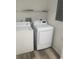 Well-equipped laundry area with washer, dryer and shelving at 197 Charter Dr. # D-8, Longs, SC 29568