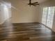 Spacious living room featuring wood-look flooring, ceiling fan, and sliding glass door to porch at 197 Charter Dr. # D-8, Longs, SC 29568