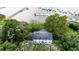 Aerial showing expansive home near waterway and docking facilities nestled amongst lush greenery at 201 River Rd., Georgetown, SC 29440