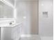 Clean bathroom featuring vanity, large illuminated mirror, and tiled shower at 201 River Rd., Georgetown, SC 29440