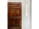 Close-up of a beautiful wooden front door with white trim and sidelight window at 201 River Rd., Georgetown, SC 29440