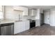 Kitchen features white cabinets, brick floors, and stainless appliances at 201 River Rd., Georgetown, SC 29440