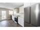 Well-lit kitchen with stainless steel appliances, brick flooring, and white cabinets at 201 River Rd., Georgetown, SC 29440