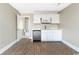 A bright kitchenette features white cabinets, a stainless steel microwave, and a stainless steel dishwasher at 201 River Rd., Georgetown, SC 29440
