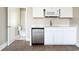 Kitchenette features white cabinets, stainless steel microwave and dishwasher, and access to the bathroom at 201 River Rd., Georgetown, SC 29440