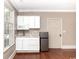 Kitchenette with white cabinets, microwave, and stainless-steel refrigerator at 201 River Rd., Georgetown, SC 29440