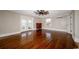 Large living room features hardwood floors, a ceiling fan, and sun-filled windows at 201 River Rd., Georgetown, SC 29440