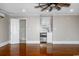 Open living room with kitchenette, ceiling fan, and doorway to the bathroom at 201 River Rd., Georgetown, SC 29440