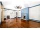 Living room boasts a wet bar, hardwood floors, and custom blue trim with a fireplace at 201 River Rd., Georgetown, SC 29440