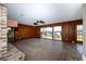 Spacious living room with wood paneling, brick fireplace, and sliding glass doors to the water at 201 River Rd., Georgetown, SC 29440
