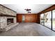 Open living room with a brick fireplace and sliding glass doors to outside at 201 River Rd., Georgetown, SC 29440