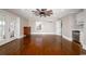Spacious living room with hardwood floors, double doors to the outside, and a kitchenette at 201 River Rd., Georgetown, SC 29440