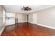 Bright living room with wood floors, kitchenette, ceiling fan, and multiple entryways at 201 River Rd., Georgetown, SC 29440