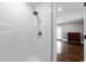Clean white tiled shower with shower head at 201 River Rd., Georgetown, SC 29440