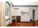 Well-lit wet bar features white cabinets, stainless dishwasher, and ample counter space at 201 River Rd., Georgetown, SC 29440