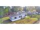 Birds eye shot of a single story house with gray siding, dark shutters, and front porch surrounded by a lawn at 2016 Misty Morning Dr., Conway, SC 29527