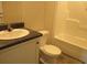 A bathroom featuring white cabinets, dark countertop, white toilet, and a white shower-tub combination unit at 2016 Misty Morning Dr., Conway, SC 29527