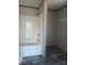 Clean bathroom featuring a tub, shower, and shelving unit, providing essential amenities in a compact design at 2016 Misty Morning Dr., Conway, SC 29527