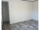 This bedroom features gray vinyl floors, neutral walls and trim, and a door leading to another room at 2016 Misty Morning Dr., Conway, SC 29527