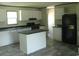 Bright kitchen features white cabinets, dark countertops, modern appliances, and an island at 2016 Misty Morning Dr., Conway, SC 29527