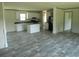 Open-concept living room featuring sleek flooring, an island, and modern finishes for comfortable and stylish living at 2016 Misty Morning Dr., Conway, SC 29527
