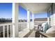 Relaxing porch with seating offers a scenic view of a pond and community at 2017 Lone Cypress Dr, Myrtle Beach, SC 29579