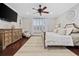 Spacious bedroom with decorative ceiling fan, hardwood floors, and a large window with plantation shutters at 208 Wahee Pl., Conway, SC 29527