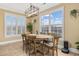 Inviting dining area with a rustic wooden table, comfortable chairs, large windows, and ample natural light at 208 Wahee Pl., Conway, SC 29527