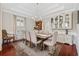 Bright dining room featuring a wooden table with upholstered chairs, a chandelier, and a built-in china cabinet at 208 Wahee Pl., Conway, SC 29527