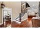 Elegant foyer featuring hardwood floors, a staircase with wrought iron railings, and views into the dining and living rooms at 208 Wahee Pl., Conway, SC 29527