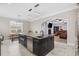 Kitchen island featuring a sink, seating, and view into a living room with a fireplace at 208 Wahee Pl., Conway, SC 29527