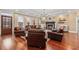 Spacious living room with hardwood floors, comfortable seating, a fireplace, and large windows providing natural light at 208 Wahee Pl., Conway, SC 29527