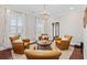 Cozy sitting area with hardwood floors, four leather chairs around a round coffee table, and natural light from the windows at 208 Wahee Pl., Conway, SC 29527