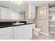 Bright bathroom featuring a vanity with a dark countertop, white cabinetry, and a mirrored wall cabinet at 2151 Bridge View Ct. # 1-1103, North Myrtle Beach, SC 29582