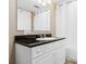 Bright bathroom featuring a white vanity cabinet, black countertop, and a large mirror at 2151 Bridge View Ct. # 1-1103, North Myrtle Beach, SC 29582