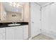 Well-lit bathroom with a spacious vanity cabinet, a large mirror and a shower behind a white curtain at 2151 Bridge View Ct. # 1-1103, North Myrtle Beach, SC 29582