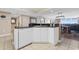 Open kitchen with granite counters, white cabinets, stainless-steel dishwasher, and dining area views at 2151 Bridge View Ct. # 1-1103, North Myrtle Beach, SC 29582
