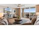 A comfortable living room with plush seating, refined decor, and a sliding door to a scenic balcony at 2151 Bridge View Ct. # 1-1103, North Myrtle Beach, SC 29582