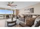 Relaxing living room featuring comfortable seating, artistic decor, and access to an inviting outdoor balcony at 2151 Bridge View Ct. # 1-1103, North Myrtle Beach, SC 29582
