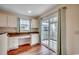 Eat-in kitchen with white cabinets, countertops, a built-in desk, and sliding glass door to backyard at 2720 Marengo Ln. # 2720, Conway, SC 29526