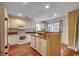 Eat-in kitchen with white cabinetry, appliances, hardwood floors and natural light at 2720 Marengo Ln. # 2720, Conway, SC 29526