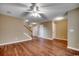 Open-concept living space with hardwood floors, ceiling fan, and staircase at 2720 Marengo Ln. # 2720, Conway, SC 29526