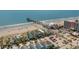 An aerial shot of beach homes with a pier stretching into the ocean at 278 Tibton Circle, Myrtle Beach, SC 29588