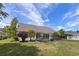 Spacious backyard featuring a black fence with lush green grass, plants, and a home exterior at 278 Tibton Circle, Myrtle Beach, SC 29588