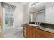 Bathroom featuring a granite countertop, wooden cabinets, and a large mirror at 278 Tibton Circle, Myrtle Beach, SC 29588