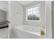 Bathroom featuring a jacuzzi tub near a window and a glimpse into the bedroom at 278 Tibton Circle, Myrtle Beach, SC 29588