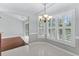 Bright dining room with white shutters, a chandelier, and tile flooring adjoining hardwood at 278 Tibton Circle, Myrtle Beach, SC 29588