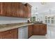 Well-lit kitchen featuring stainless steel appliances and brown cabinets with granite countertops at 278 Tibton Circle, Myrtle Beach, SC 29588