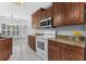 Spacious kitchen featuring wood cabinets, white appliances, and granite countertops at 278 Tibton Circle, Myrtle Beach, SC 29588