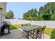 A backyard with a small patio space, a dining table, a grill, and a white vinyl fence at 308 Golan Circle # A, Myrtle Beach, SC 29579